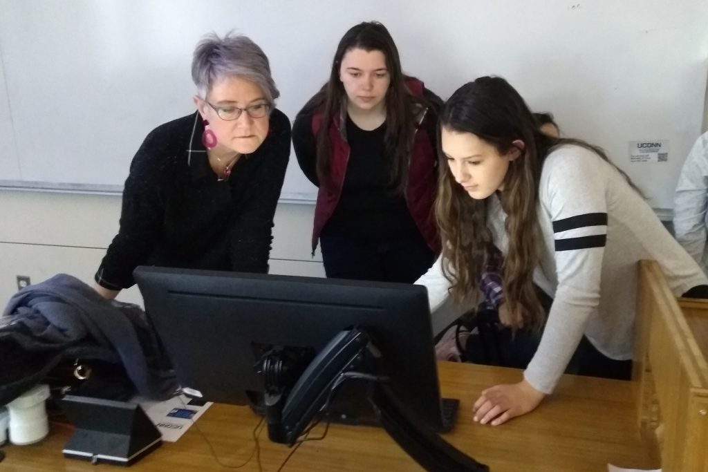 instructor and students working at computer